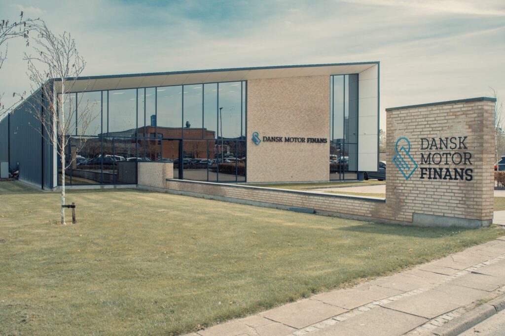 a building with glass walls and a lawn