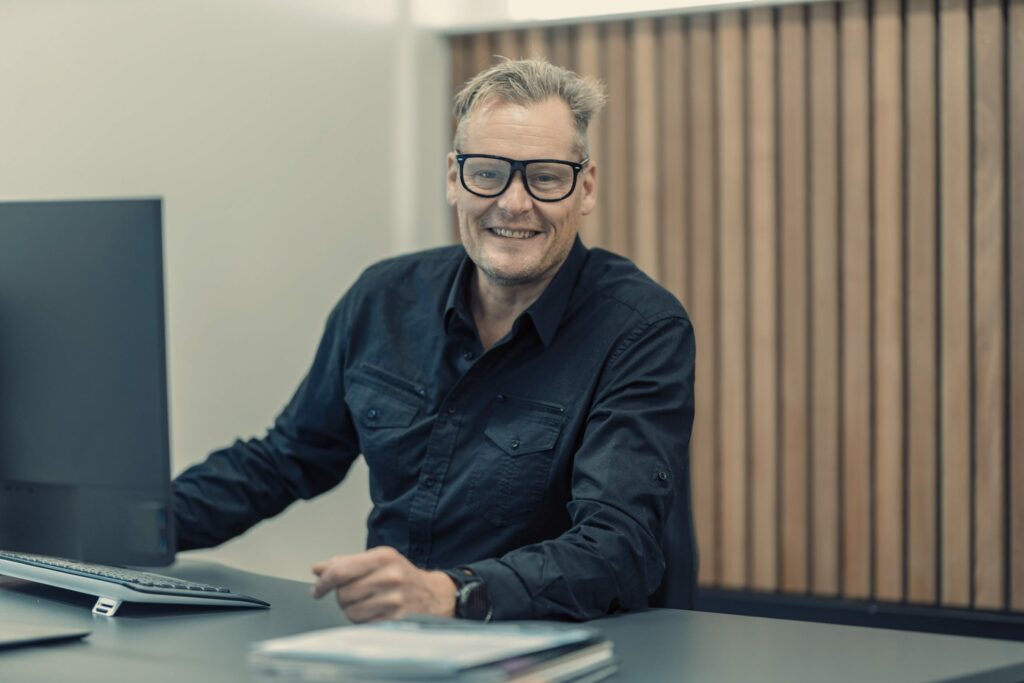 a man sitting at a desk with a computer