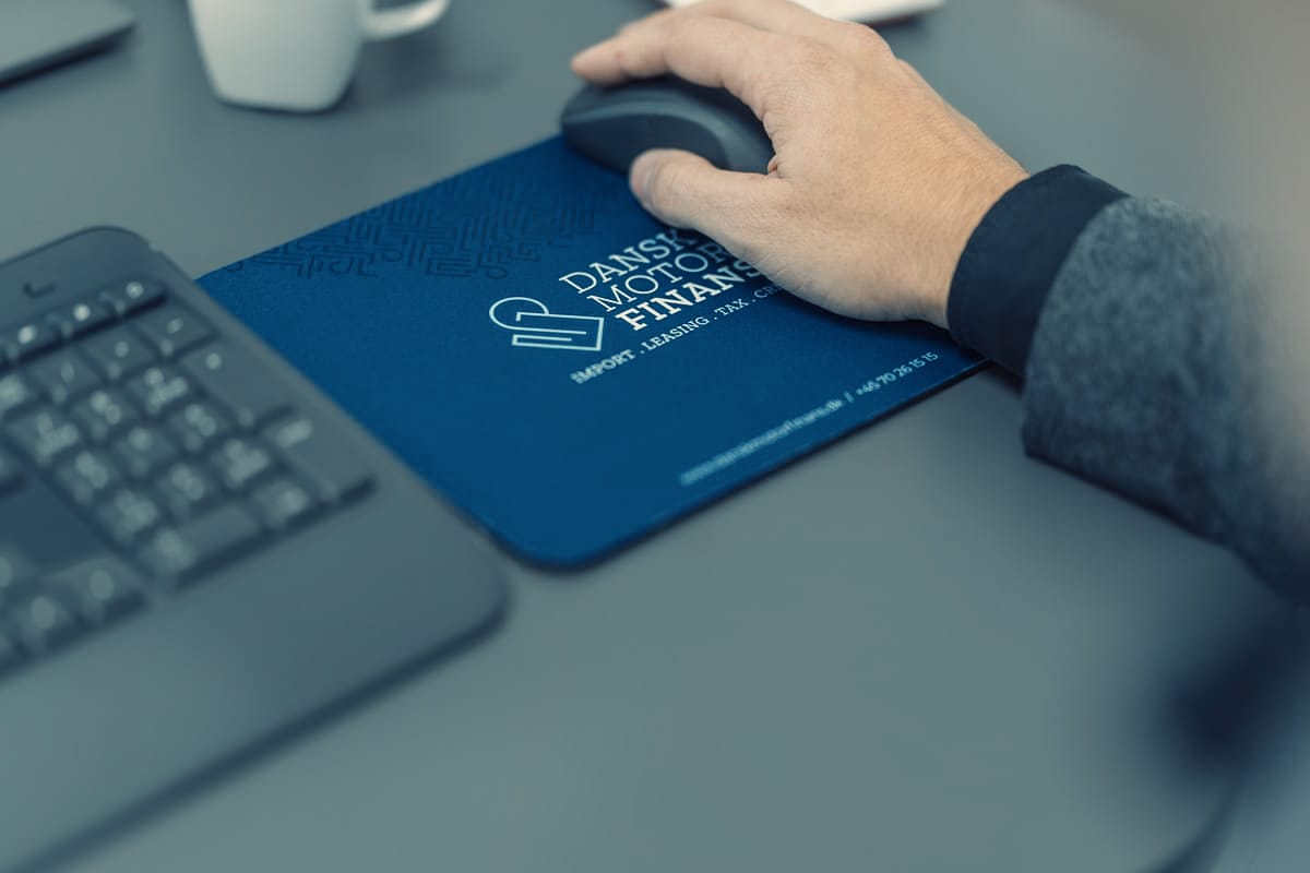 a hand on a mouse pad