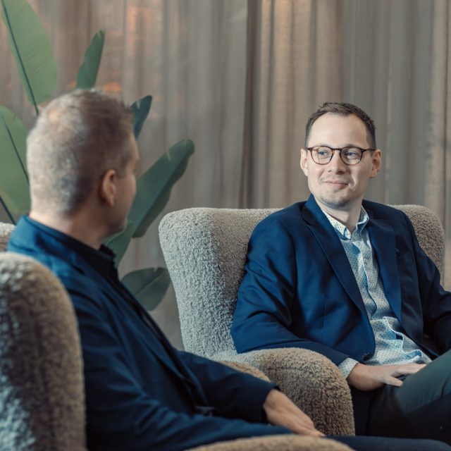a man in suit sitting in a chair